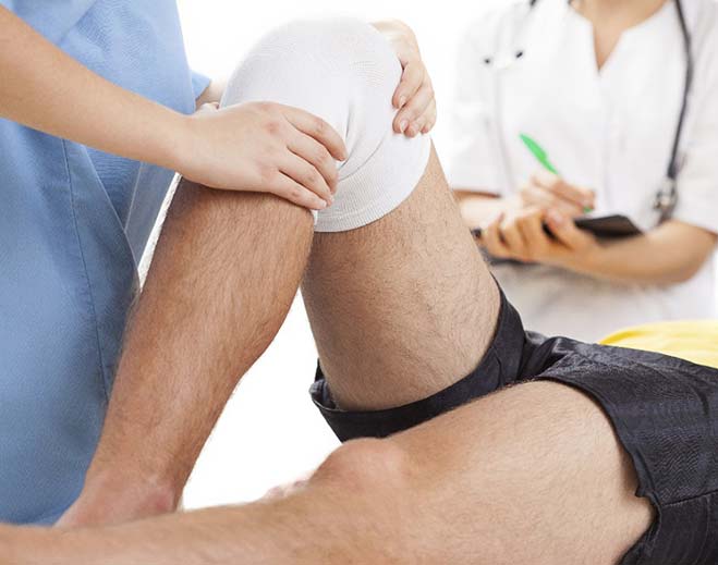 doctor examining patient's knee
